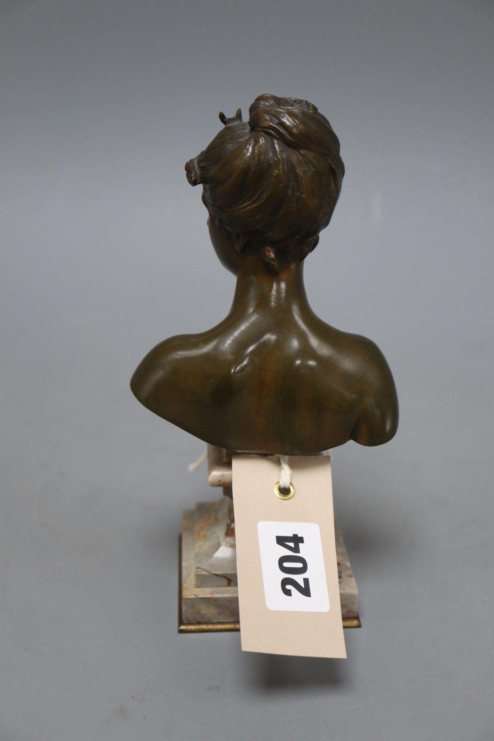 After Moreau. A bronze bust of a young lady, signed, height 19cm